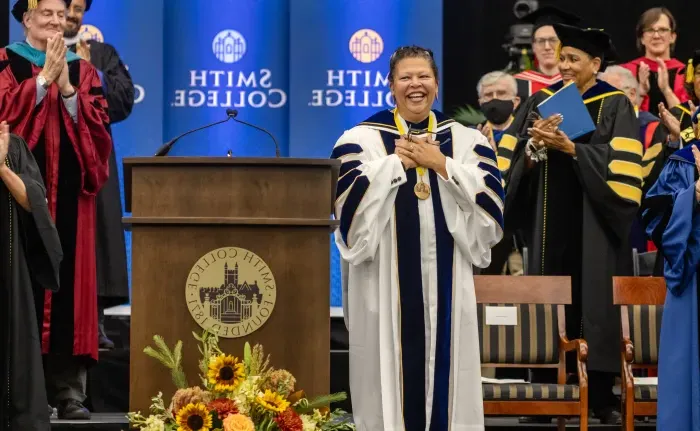 莎拉Willie-LeBreton smiles on stage at her inauguration.